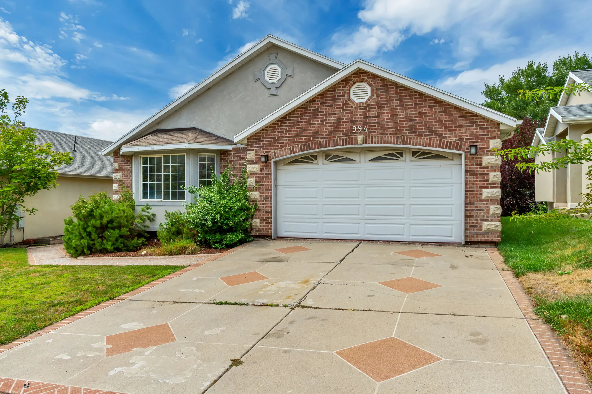 Brick facade with stone accents and a two-car garage