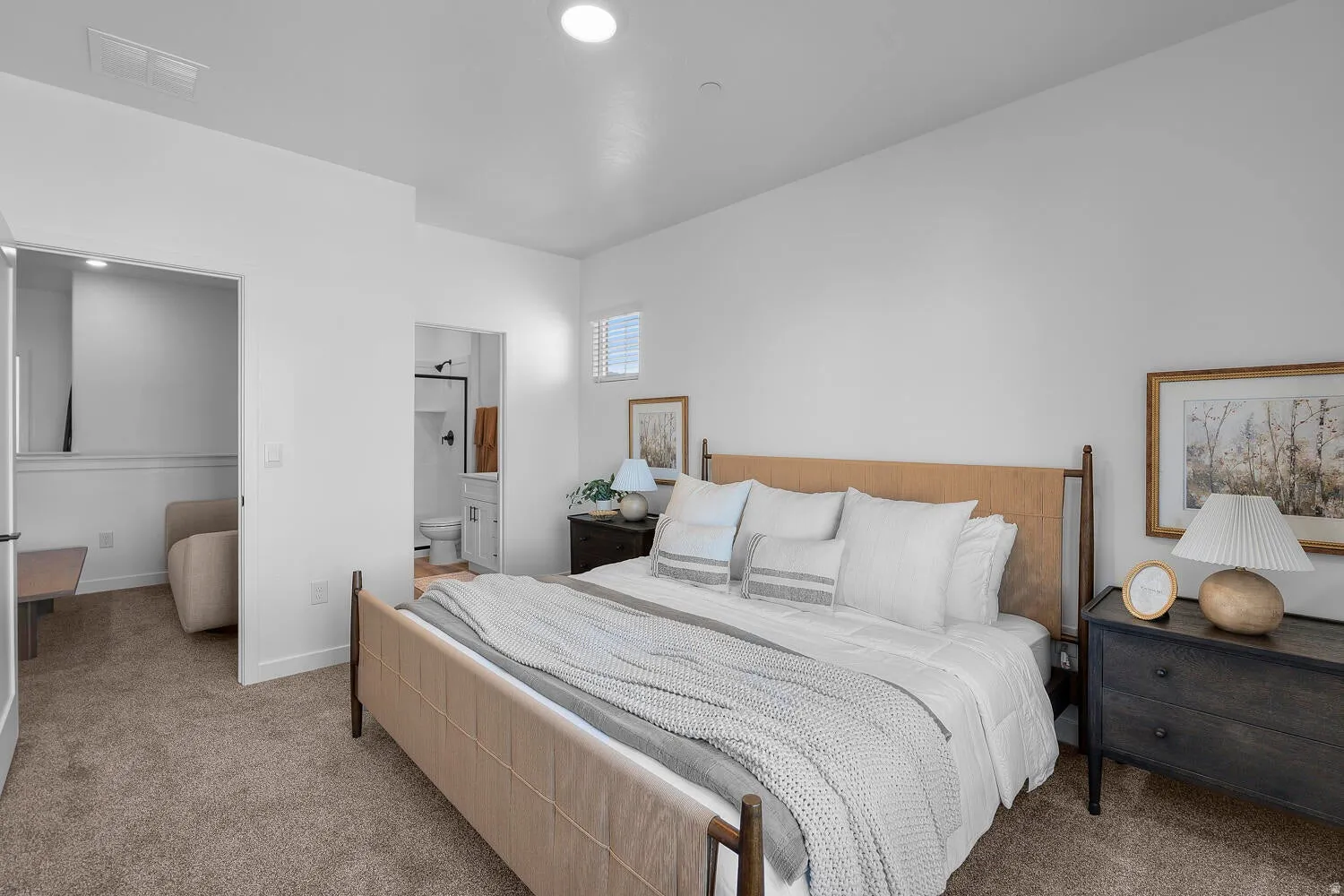 Carpeted bedroom with a window, recessed lighting, and an entryway to an adjoining bathroom