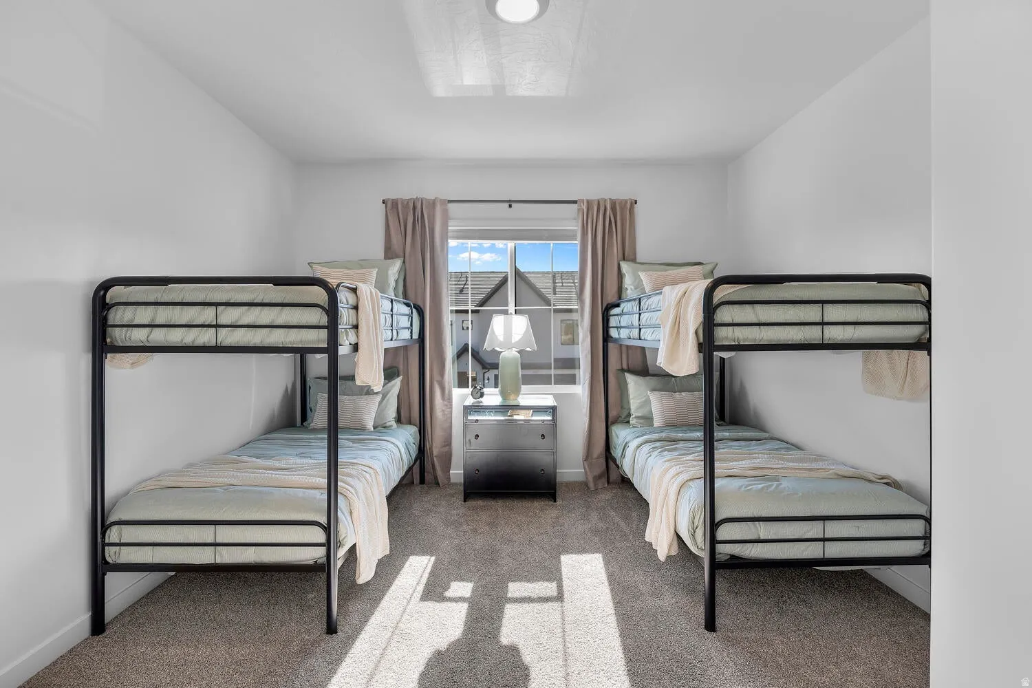 Carpeted room with a central window, recessed lighting, and white walls