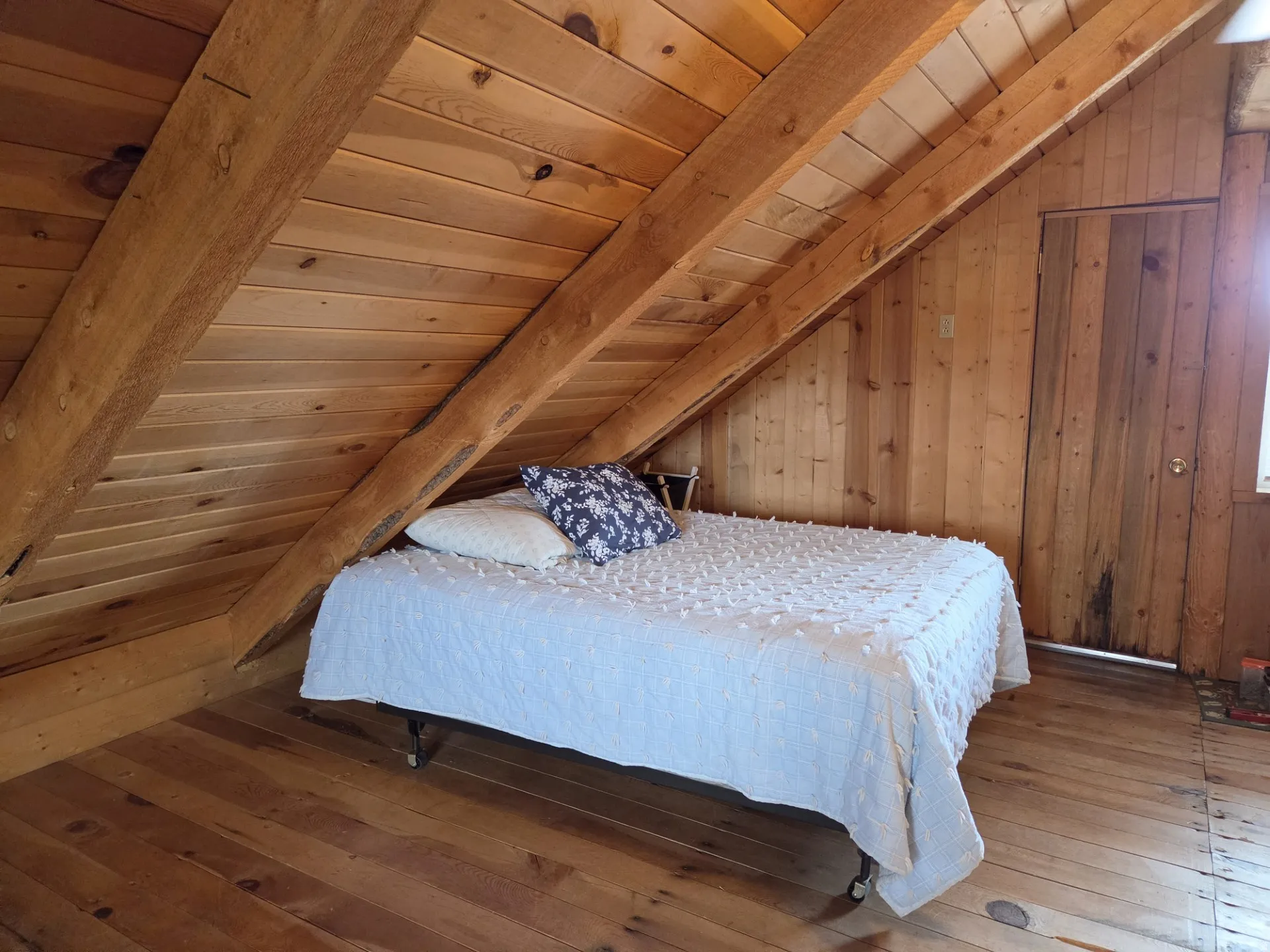 Wood-paneled walls and ceiling with exposed wood beams