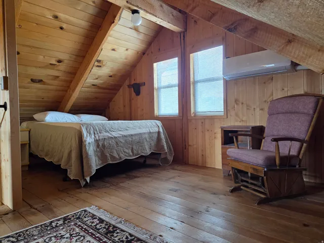 Wood-paneled walls and ceiling with exposed wood beams