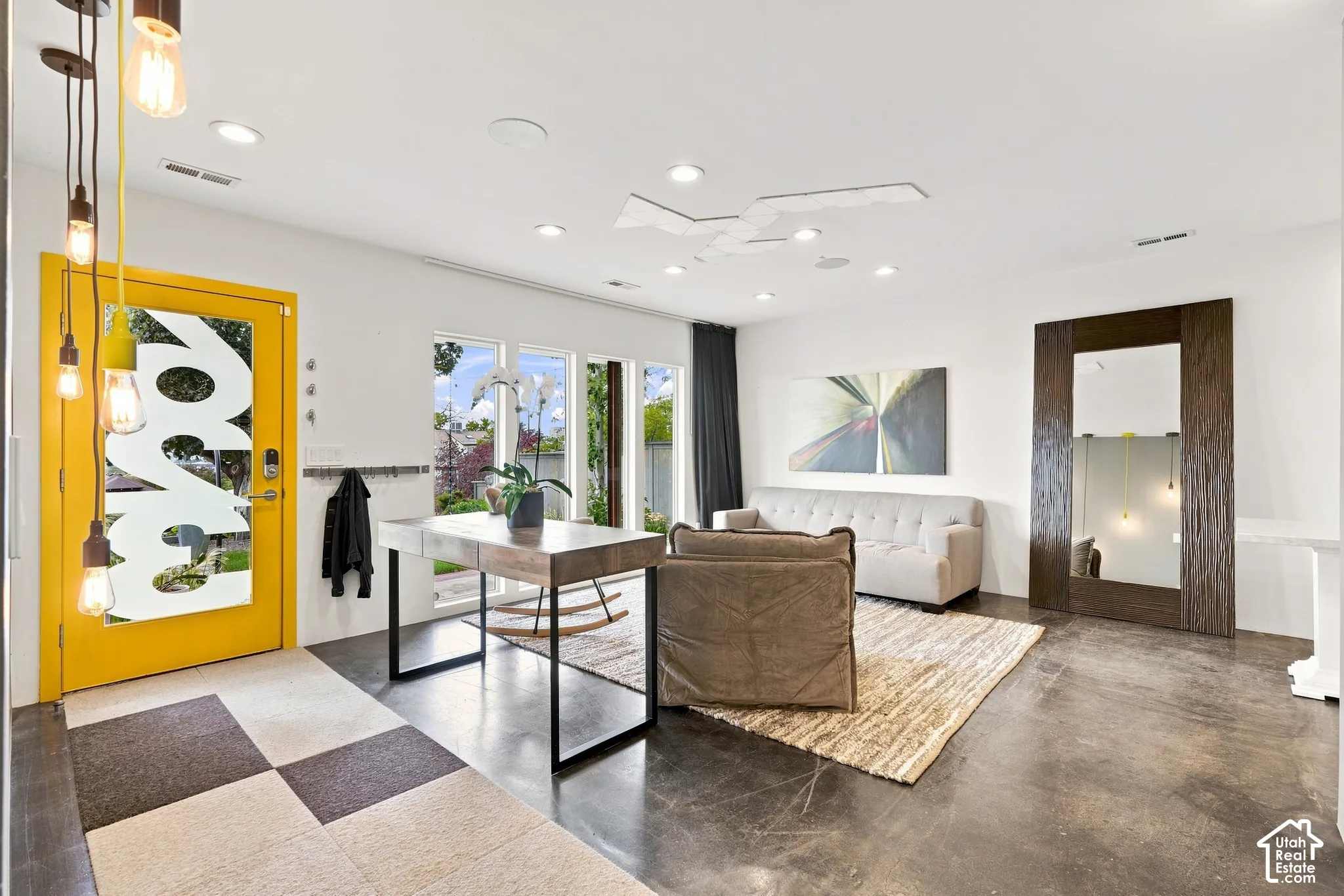 Polished concrete flooring, recessed lighting, and a modern ceiling fan