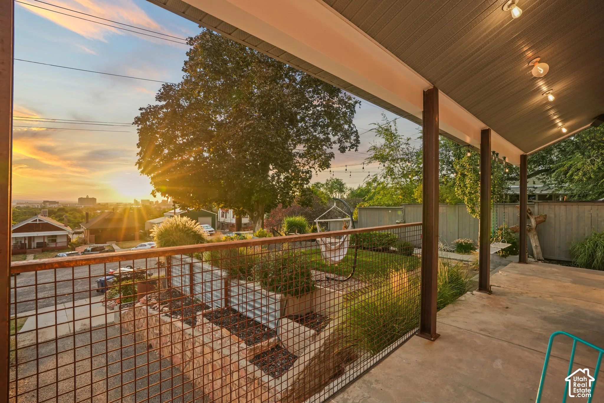 Covered outdoor patio with exposed beam ceiling and recessed lighting