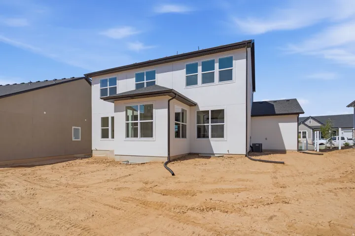 Modern two-story residence featuring a clean-lined architectural design with white exterior finish, dark roof accents, and expansive multi-pane windows