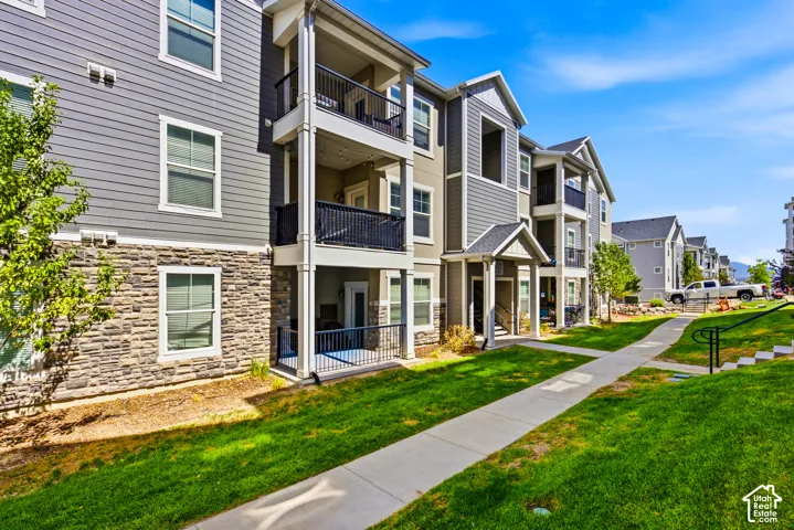 Multi-story residential buildings featuring horizontal siding and stone veneer accents