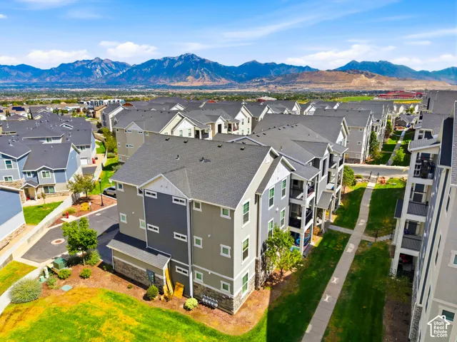 Modern multi-story residence featuring clean architectural lines, composite shingle roofing, and a contemporary color palette of gray and white exterior finishes