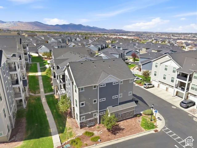 Aerial view of a modern residential community featuring contemporary multi-unit homes with charcoal and neutral exterior finishes, clean architectural lines, and manicured landscaping