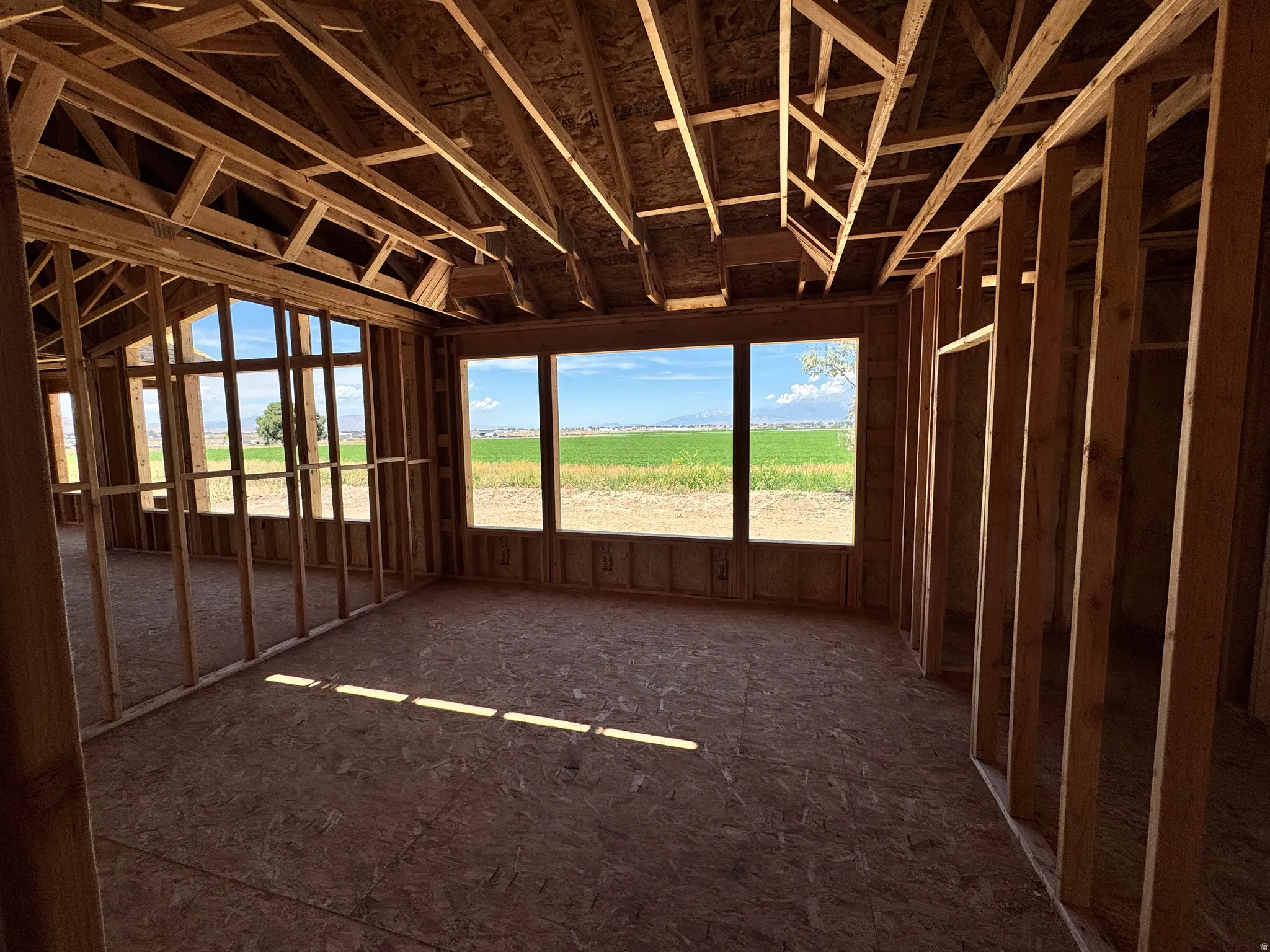 Interior framing with engineered wood subfloor and multiple large windows