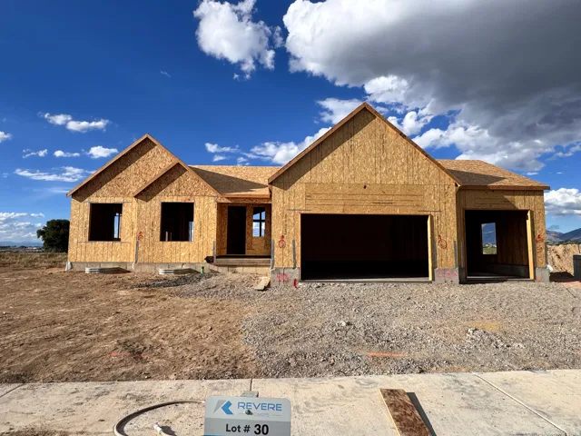 New construction framed residence with an attached garage and a covered entry