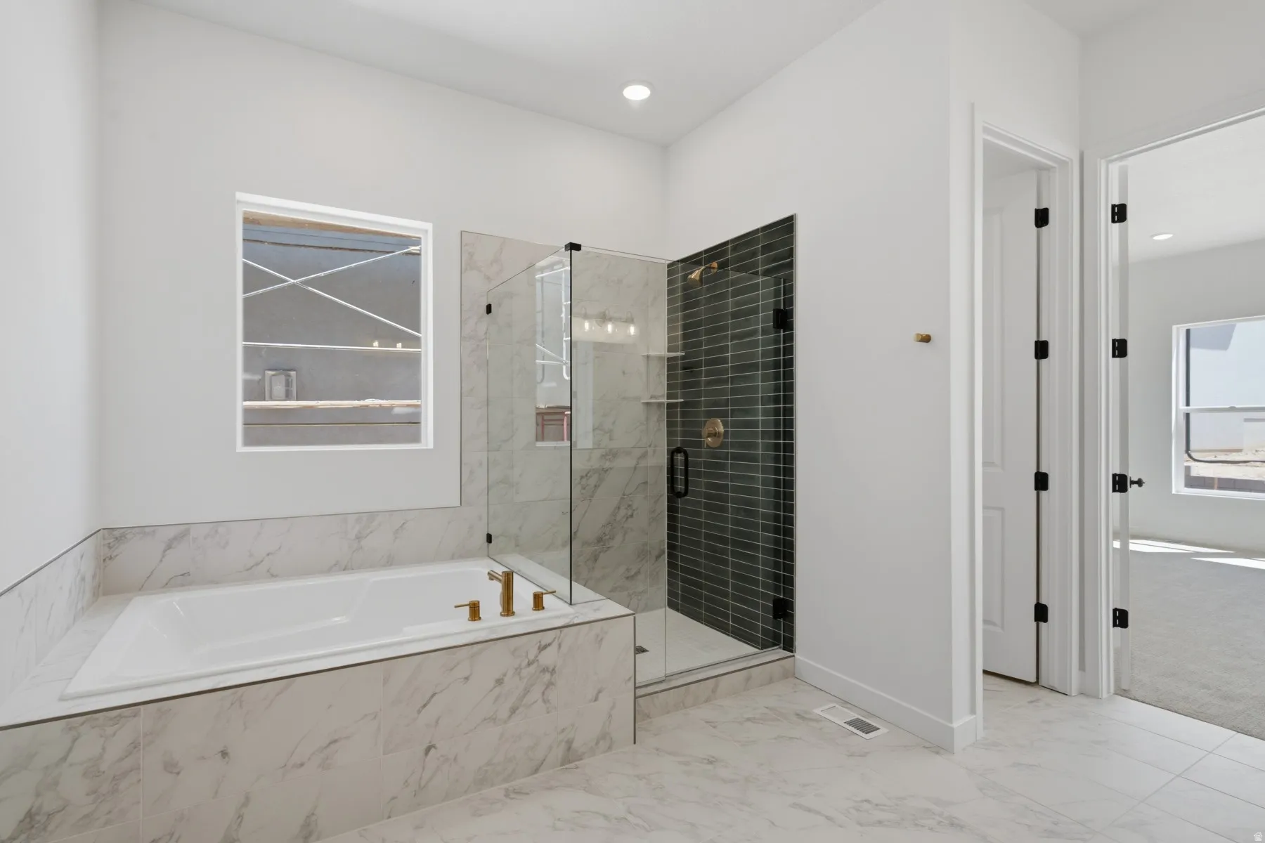 Built-in soaking tub with gold-finish fixtures