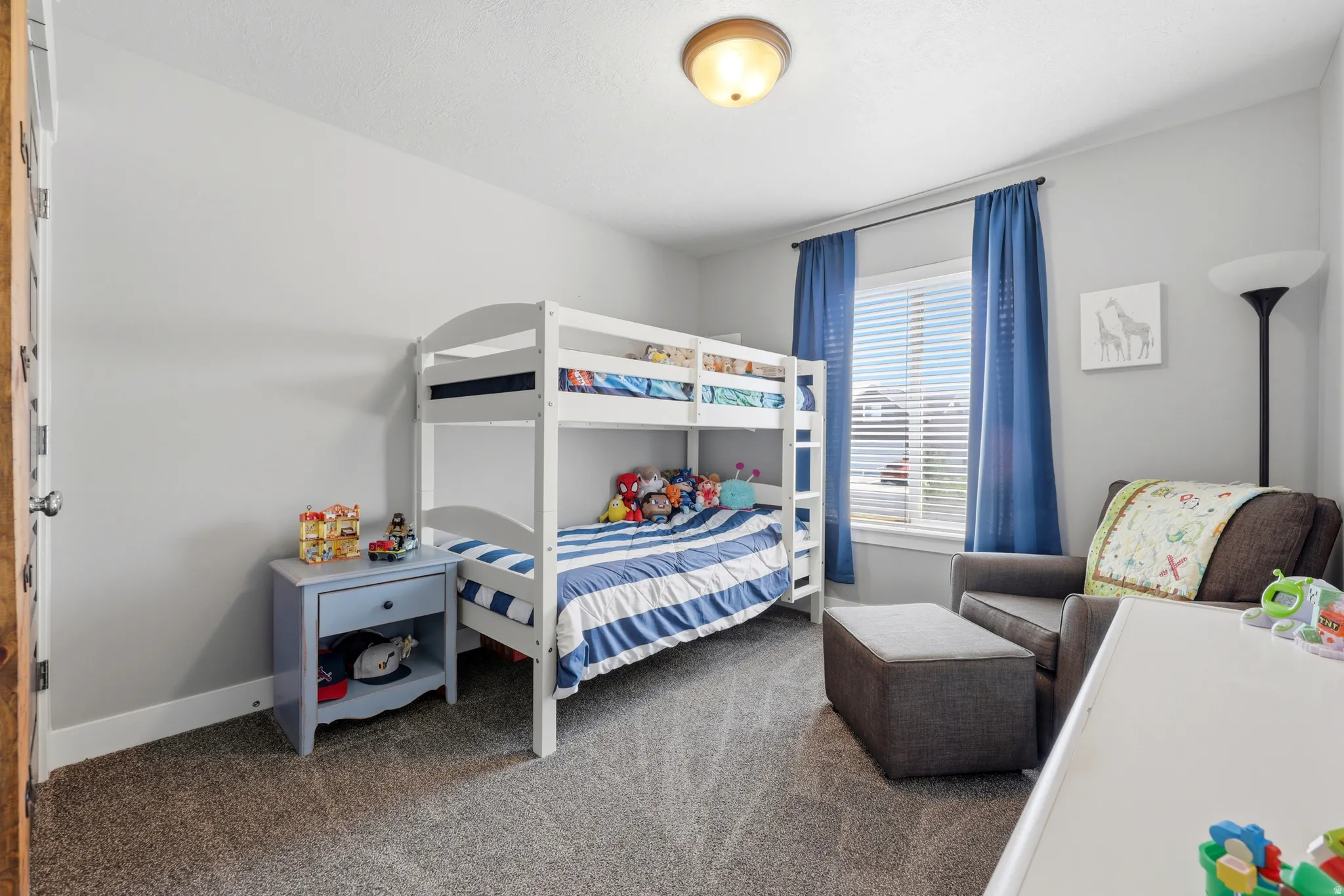 Carpeted flooring, white trim, light gray painted walls, and a ceiling-mounted light fixture