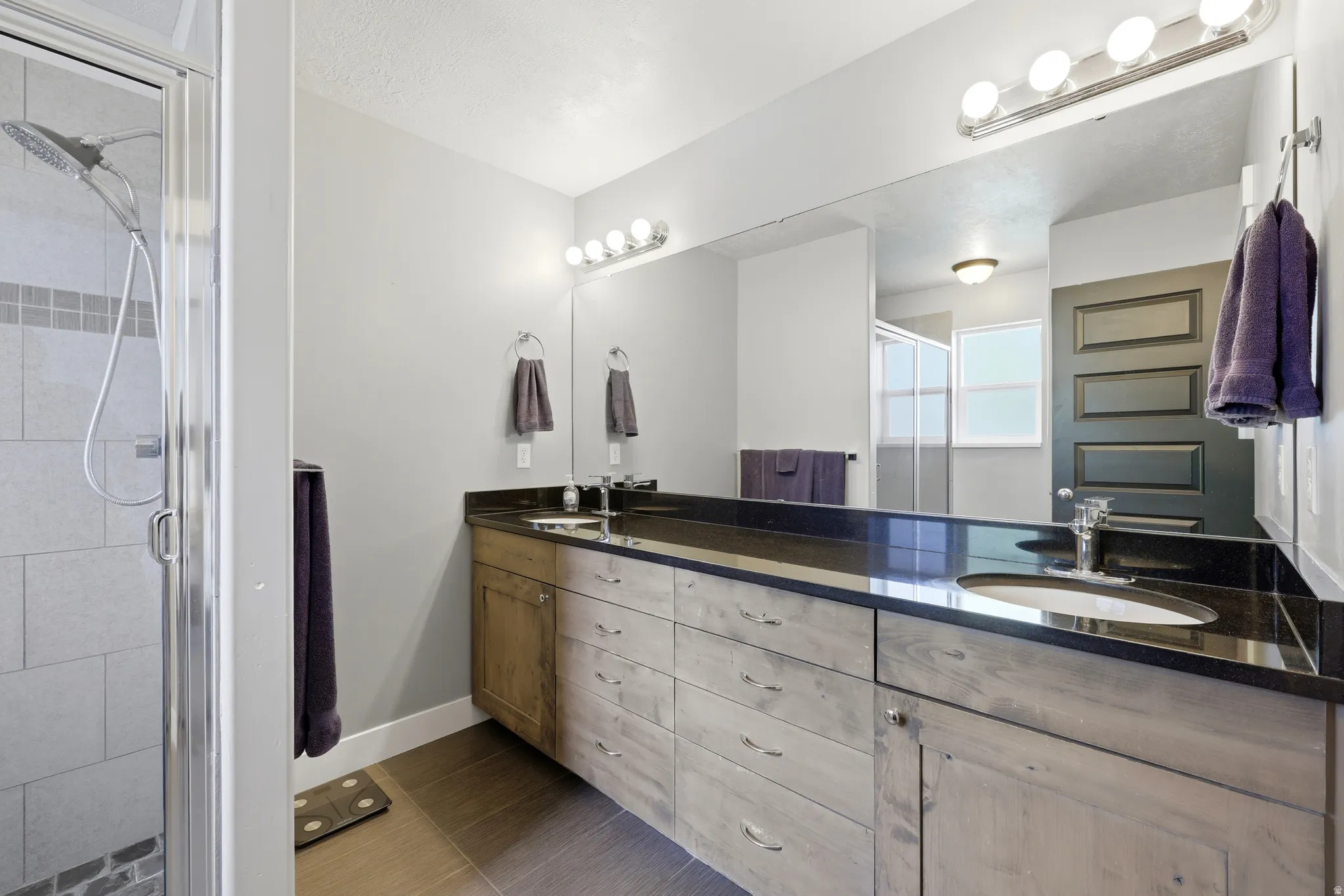 Dual vanity with dark countertops and integrated sinks