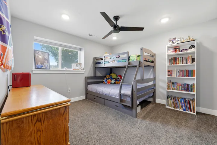 Carpet flooring, recessed lighting, ceiling fan, and a built-in window