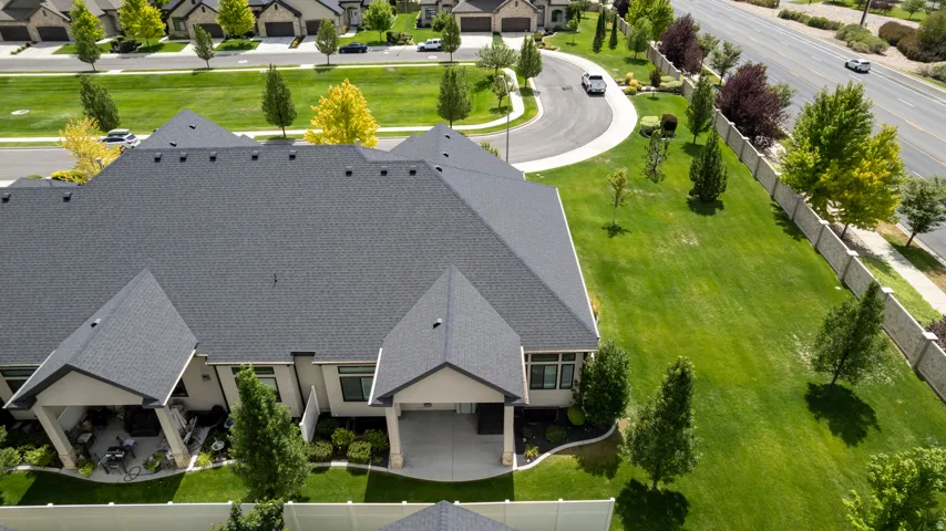 Expansive lot featuring a meticulously maintained lawn and mature trees