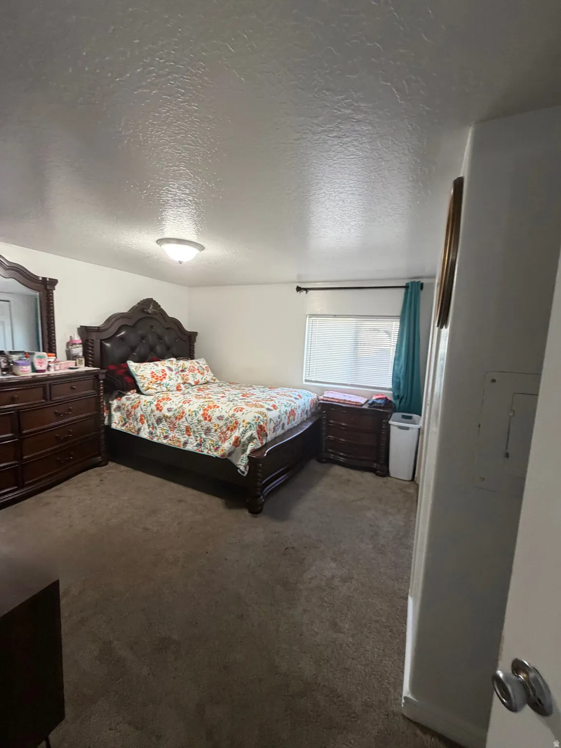 Carpeted flooring, recessed window, and overhead flush-mount lighting