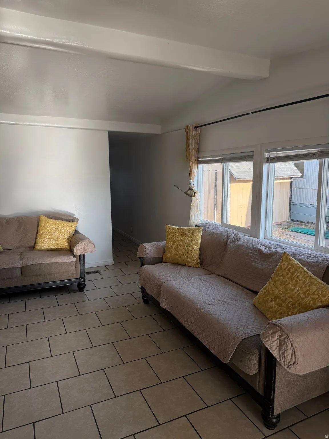 Tile flooring throughout with multiple large windows