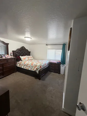 Carpeted flooring, recessed window, and overhead flush-mount lighting