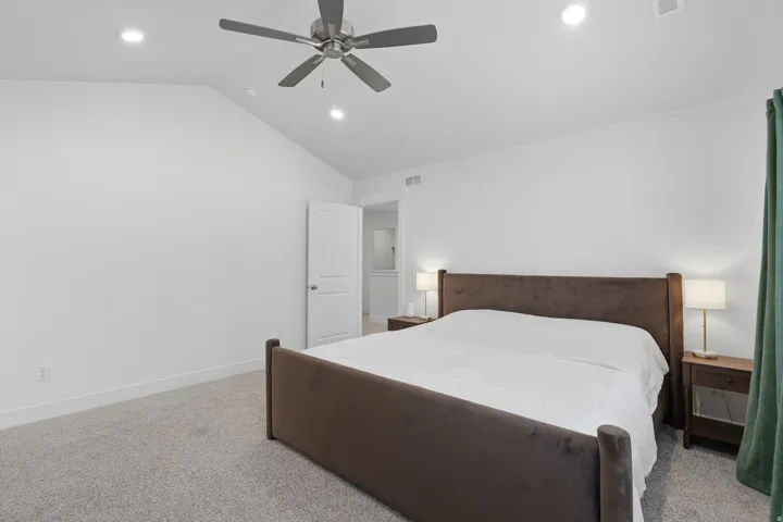 Vaulted ceiling with recessed lighting and a ceiling fan