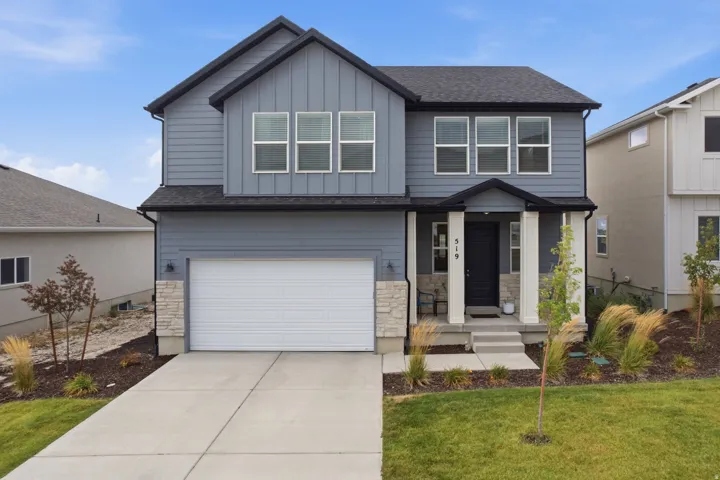 Two-story residence featuring a dark asphalt shingle roof, blue siding, and white trim
