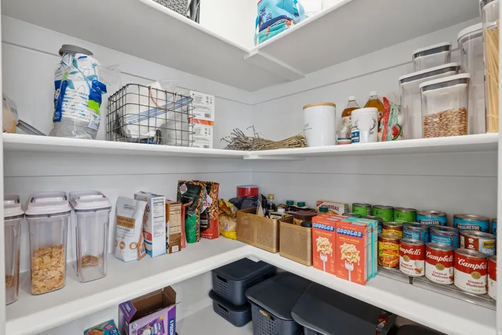 Built-in pantry shelving featuring multiple tiers and white finishes