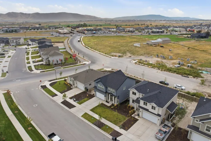 Newly constructed residences featuring paved driveways and landscaped front yards