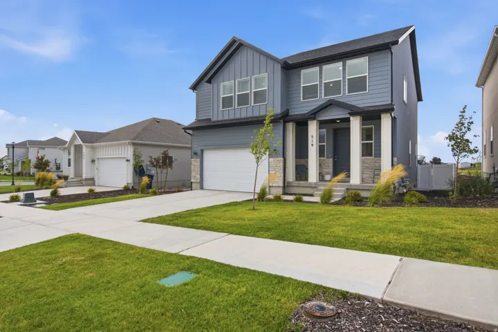 Two-story exterior with a gray siding finish, white trim, and a prominent front porch