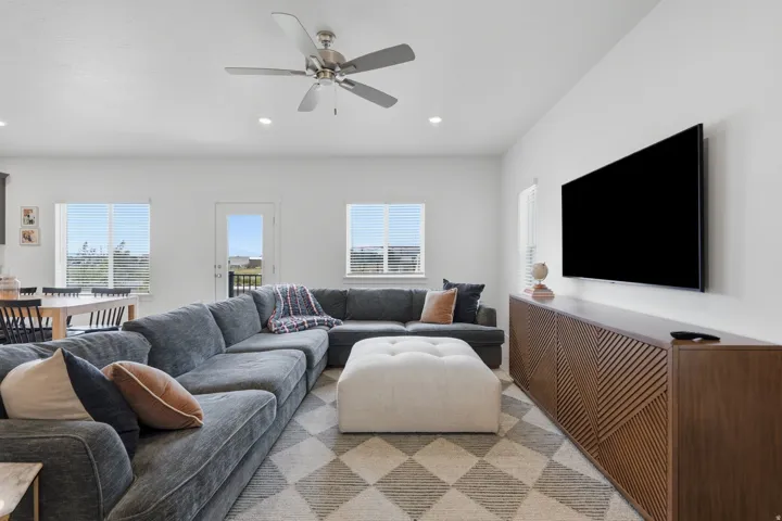 Recessed lighting, ceiling fan, and multiple windows with blinds