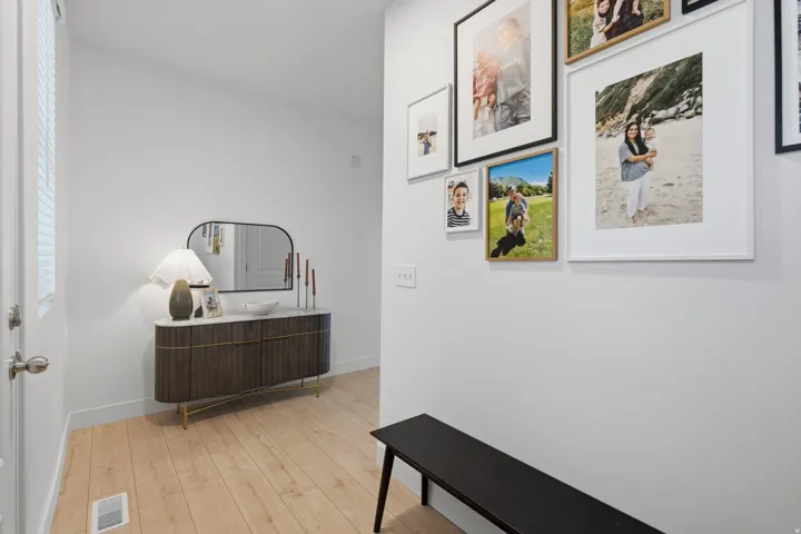 Light wood-finish flooring, white walls, and white trim