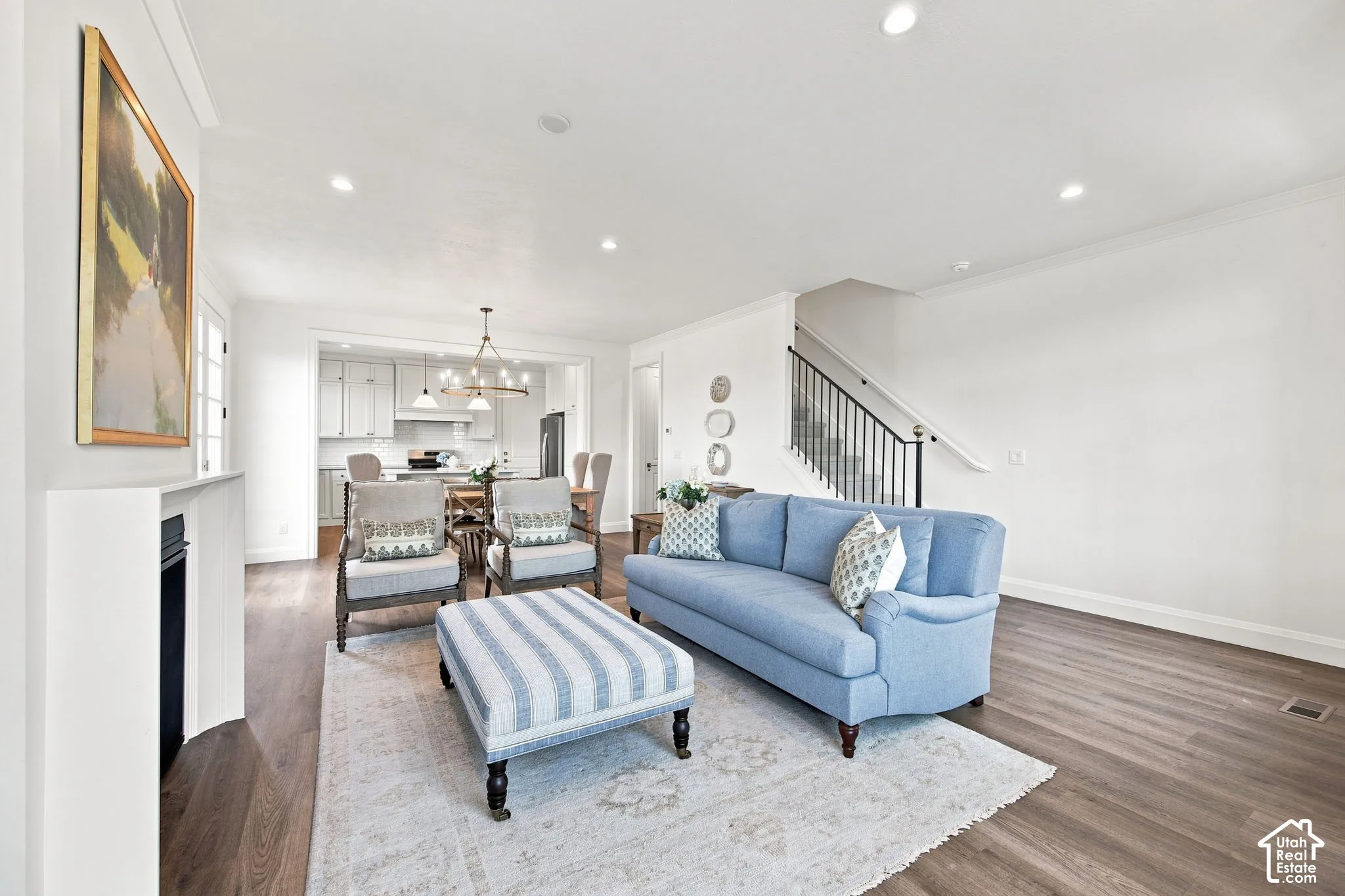 Model Home - Open-concept living area with wood-finish flooring, recessed lighting, and a built-in fireplace