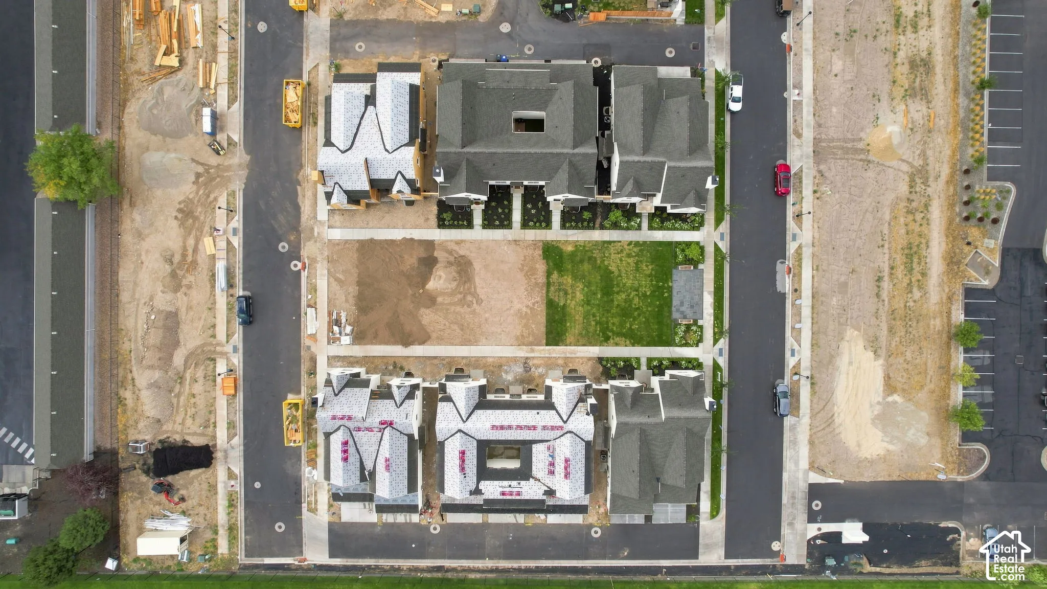 Multiple residential structures with dark shingle roofs