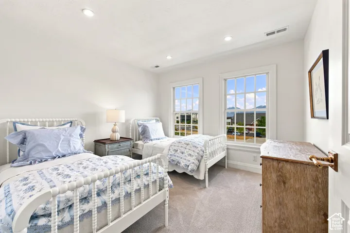 Model Home - Recessed ceiling lighting, two windows with gridded panes, light-colored carpeting, and painted white walls
