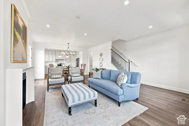 Model Home - Open-concept living area with wood-finish flooring, recessed lighting, and a built-in fireplace