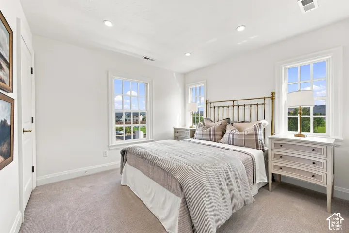 Model Home - Recessed ceiling lighting, white walls, two double-hung windows, and light-colored carpeting