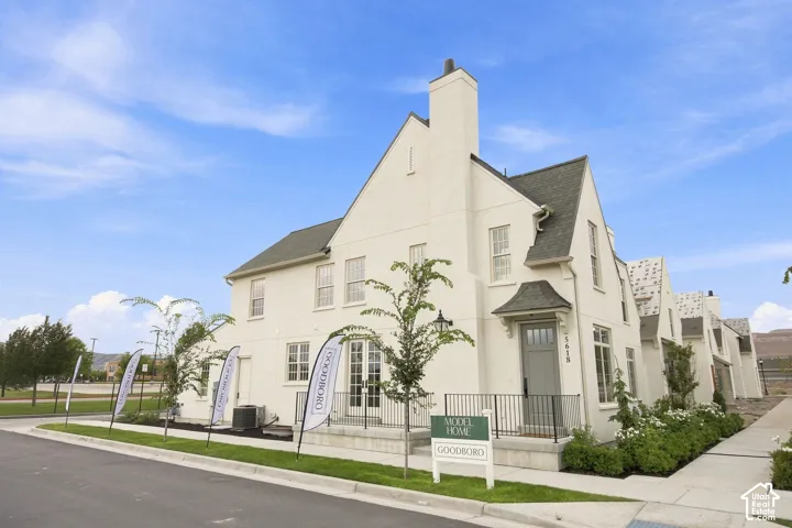 Model Home - Stucco exterior with multiple gables and a prominent chimney