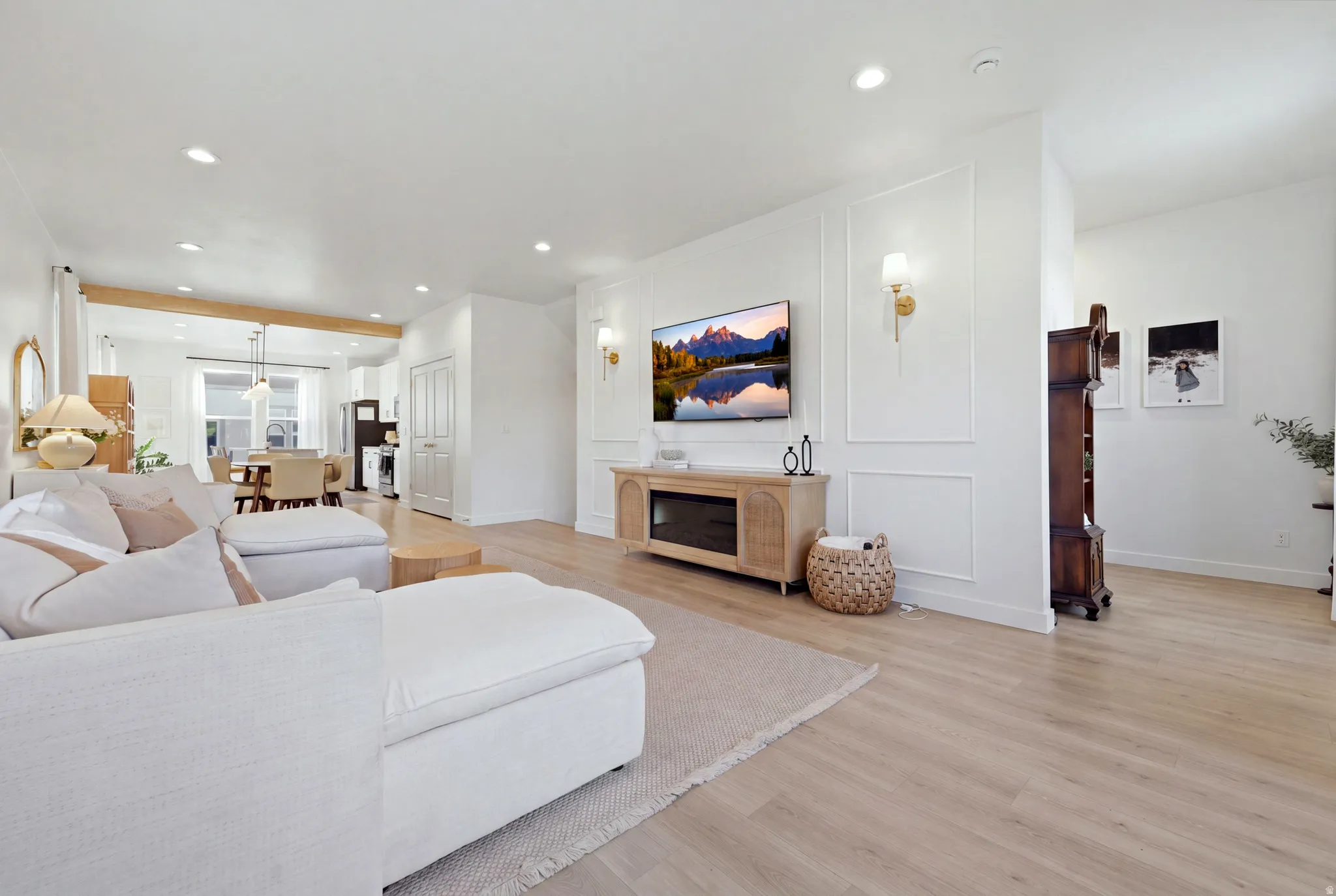 Recessed lighting, light wood-finish flooring, and white walls