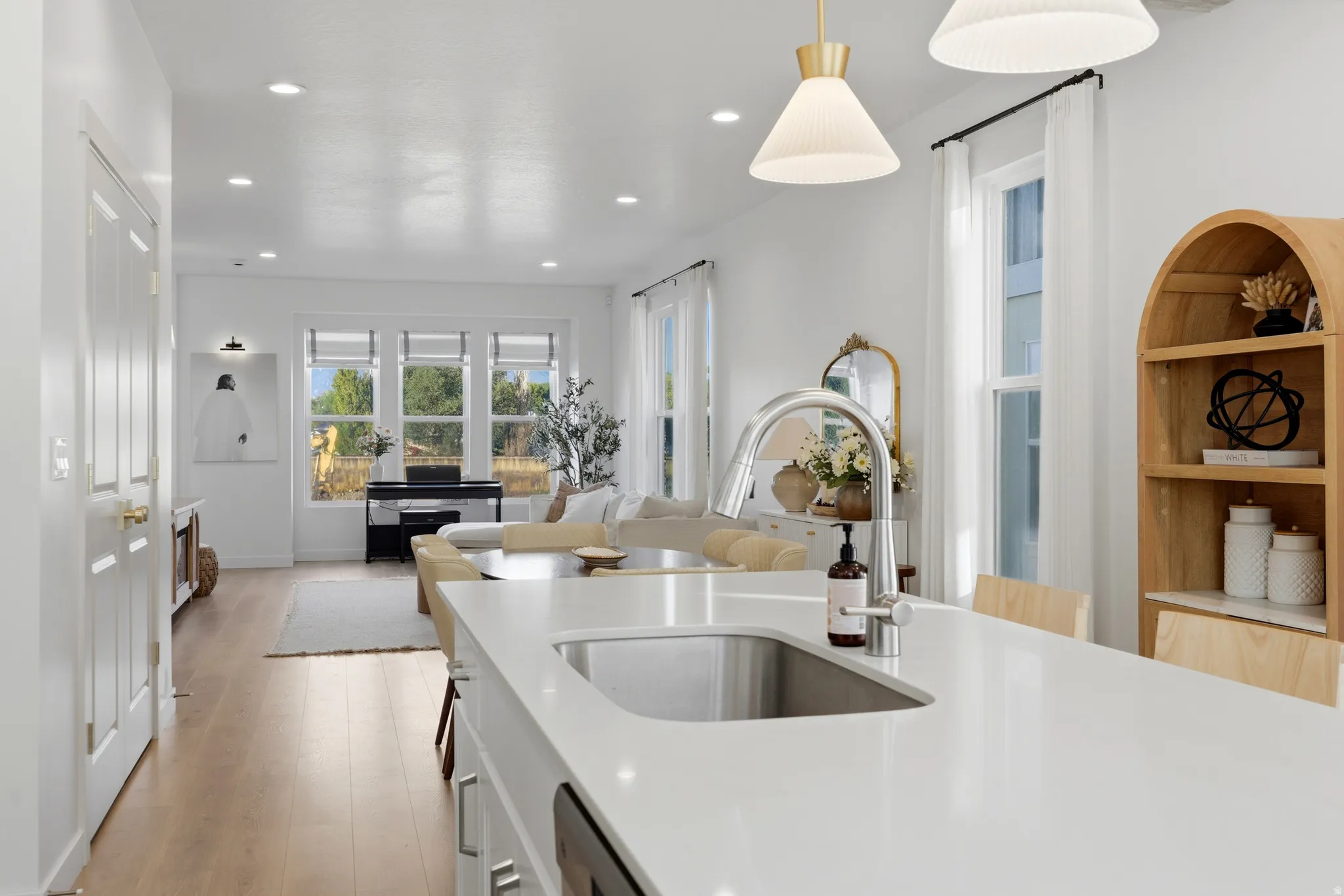 Contemporary kitchen island with an undermount sink and gooseneck faucet