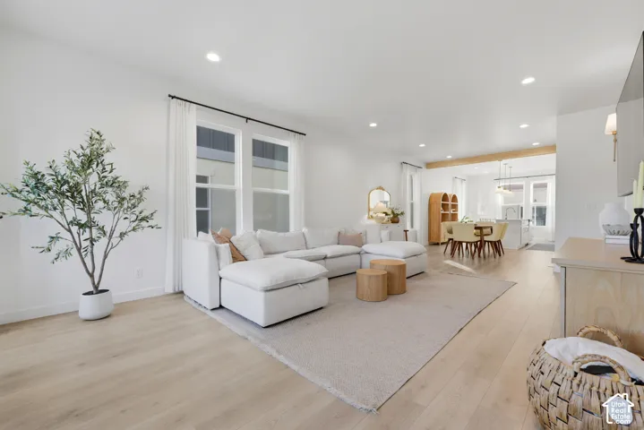 Recessed lighting, wood-finish flooring, multiple large windows, and an open-concept design