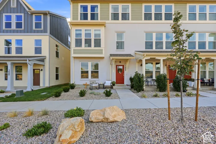 Multi-story stucco and siding exterior with multiple windows