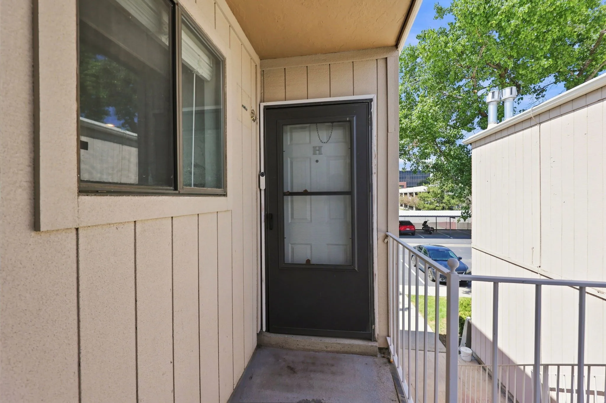 Entry featuring a dark-framed glass paneled door and an adjacent sliding window