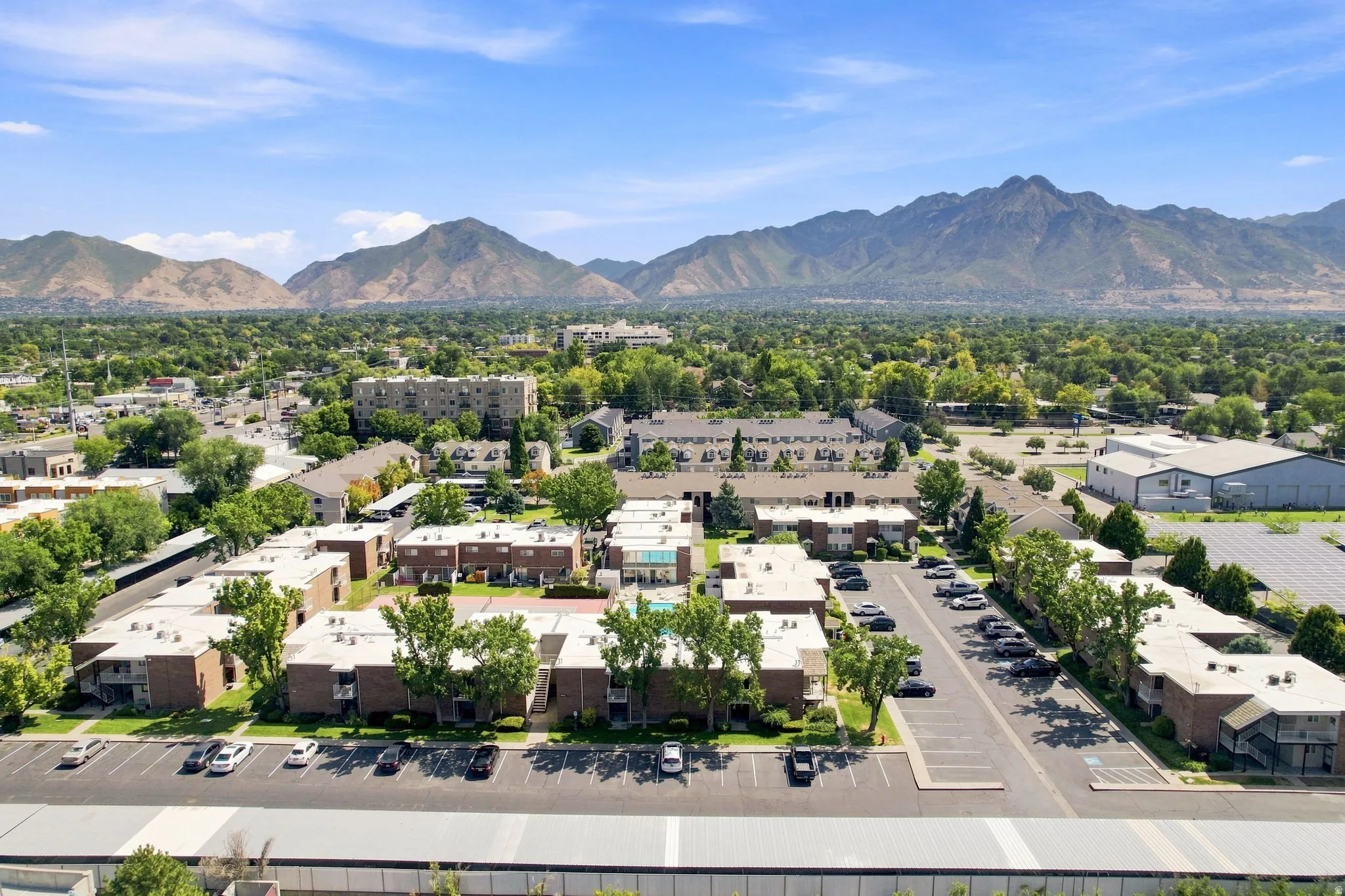 Spacious multi-building property featuring a central swimming pool and ample surface parking