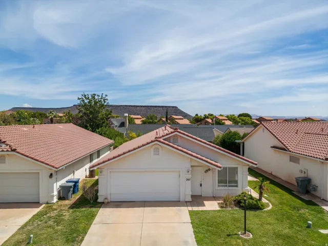 Single-story residence with a stucco exterior and a terracotta-style tile roof