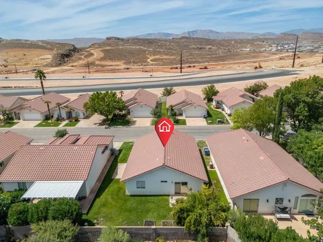 Single-story residential property with a terracotta tile roof and stucco exterior