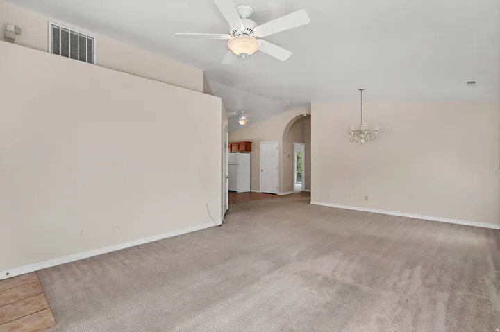 Vaulted ceiling with an attached ceiling fan and light fixture