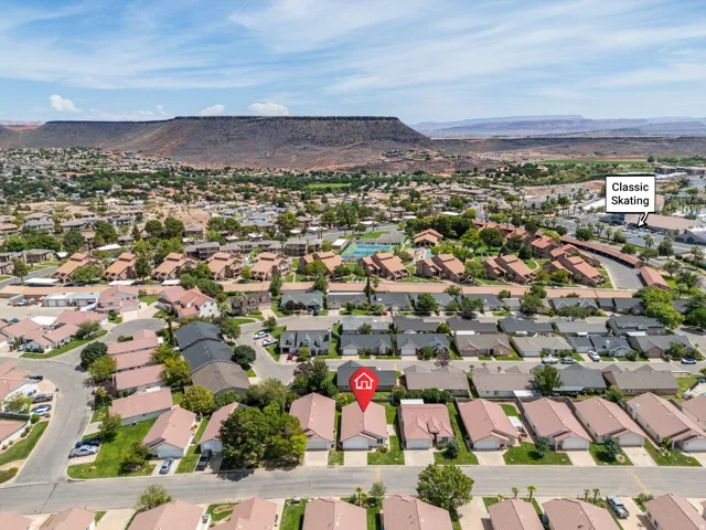 Aerial view of a residential neighborhood with surrounding desert landscape and mountain backdrop