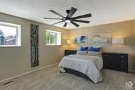 Room featuring two windows, neutral wall tones, and installed carpeting