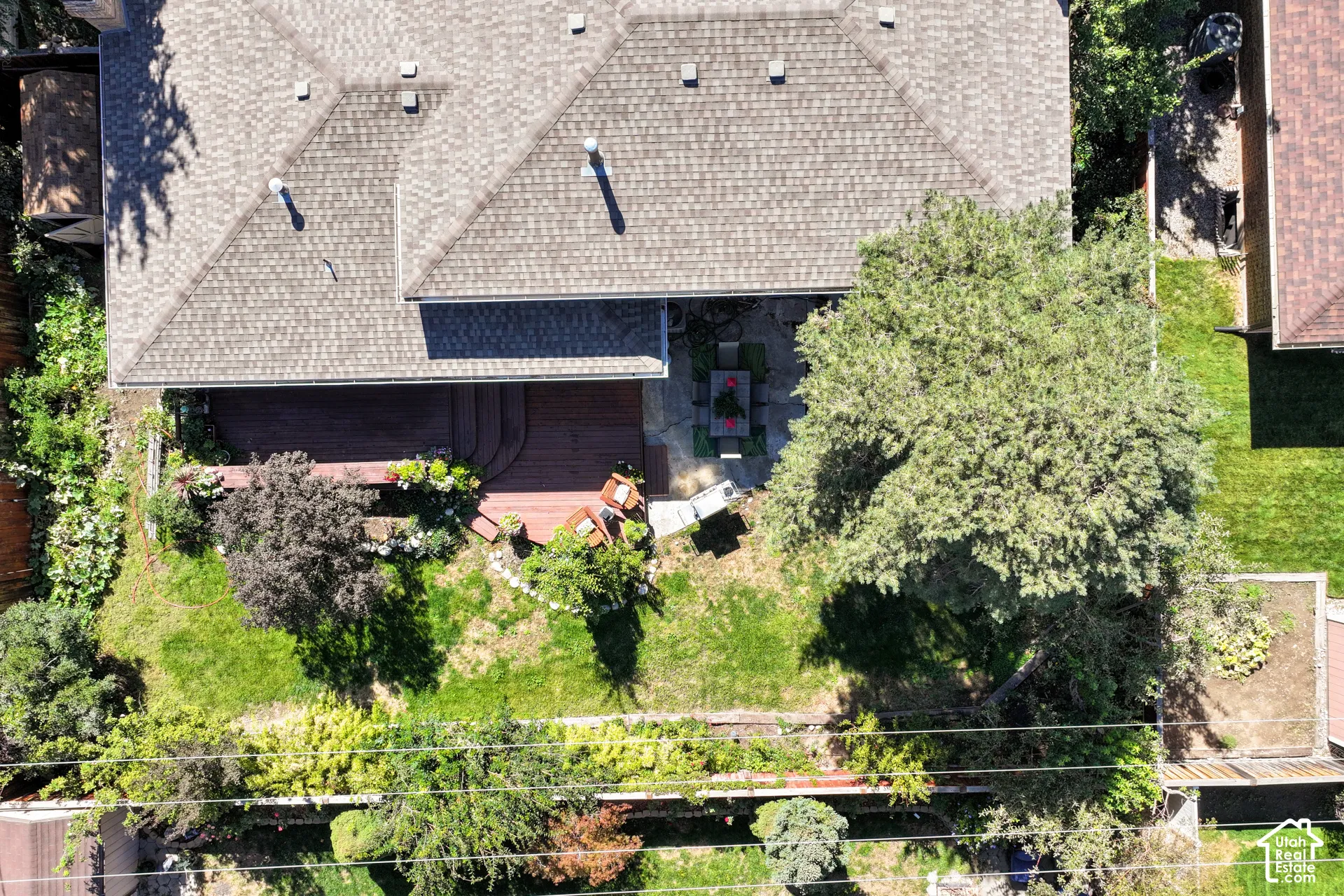 Arial yard view displaying the balanced mix of sunny and shade areas, patio/deck and green spae.