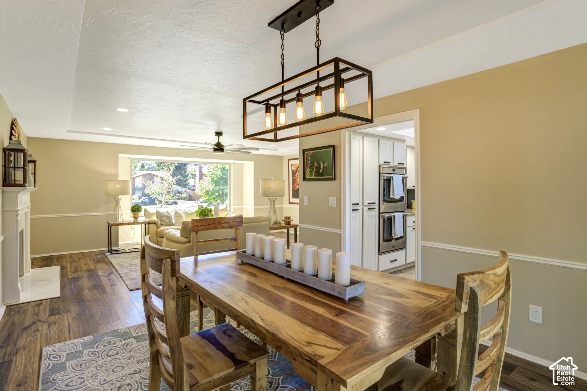 Open concept living area featuring wood-finish flooring, a decorative fireplace, and a contemporary chandelier