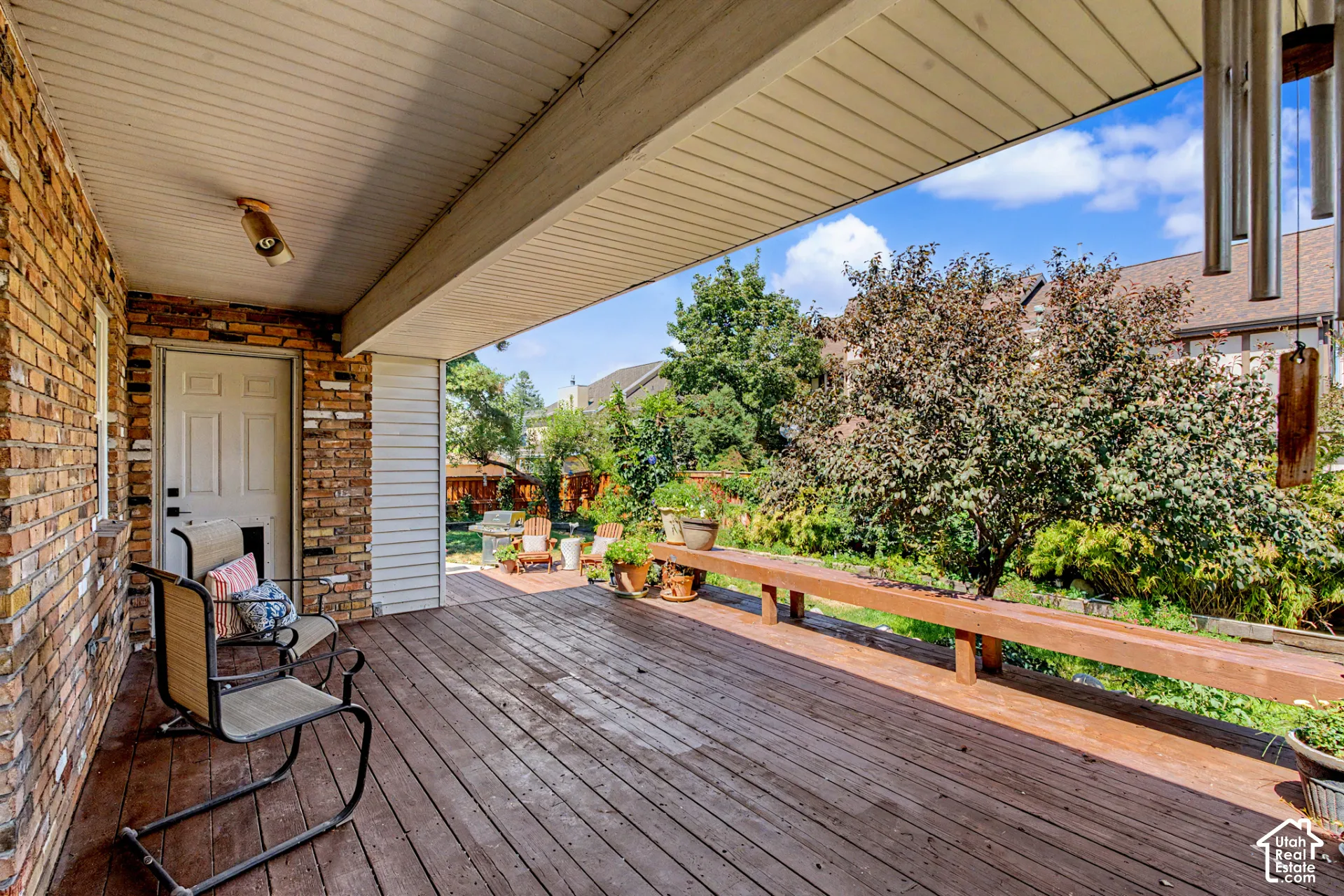 Covered patio with wood-finish decking, and built-in bench seating