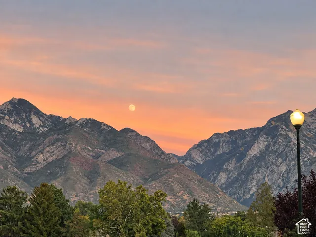 Mountain backdrop with natural foliage, illuminated streetlamp