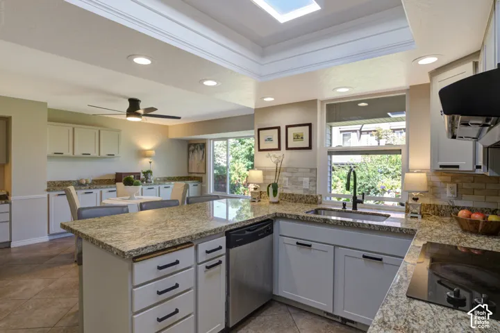Kitchen, recessed lighting, cabinetry, granite countertops, natural light through large newly installed windows